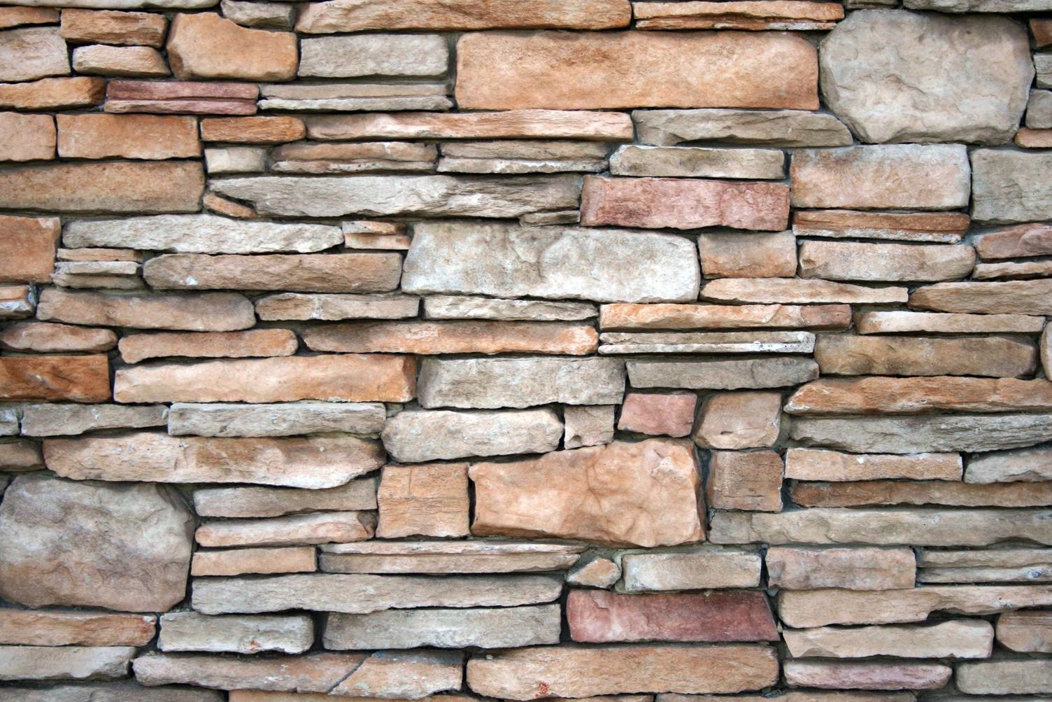 Close-up of dry-stacked natural stone showing the texture of the wall face
